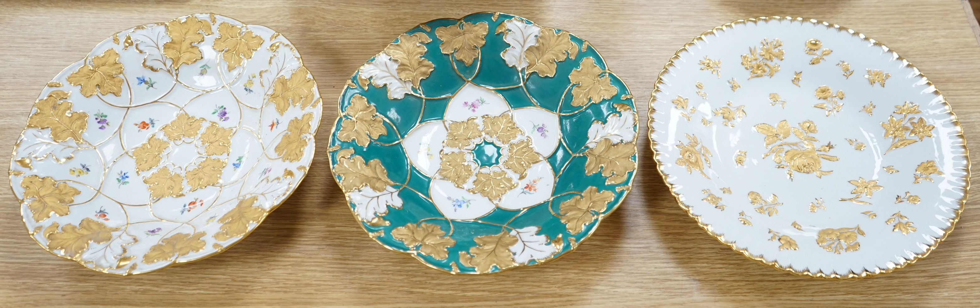 Two Meissen floral and gilt dishes and another shallower dish, 28cms diameter (3)